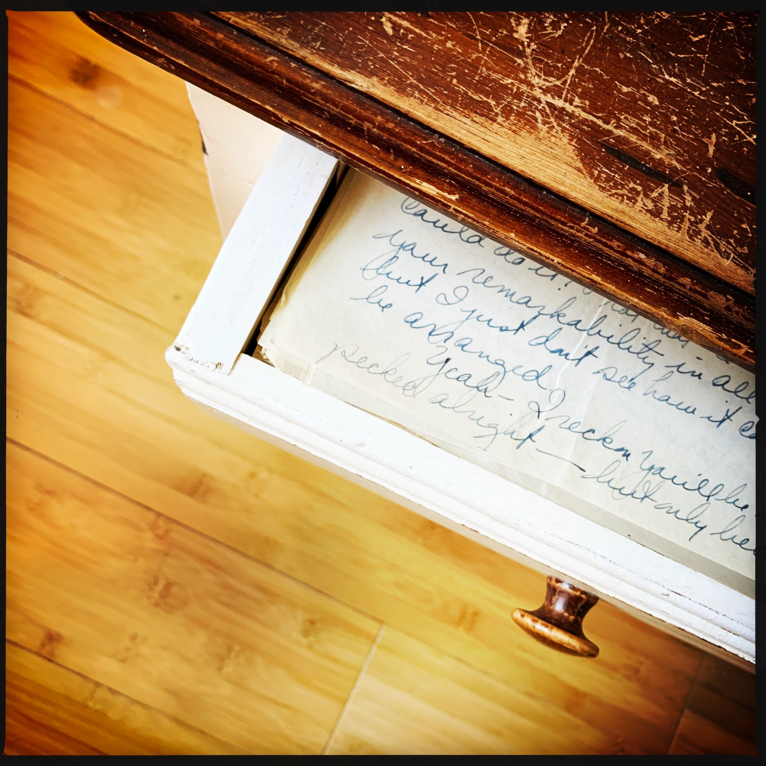 Old family letters laid across a dark desk