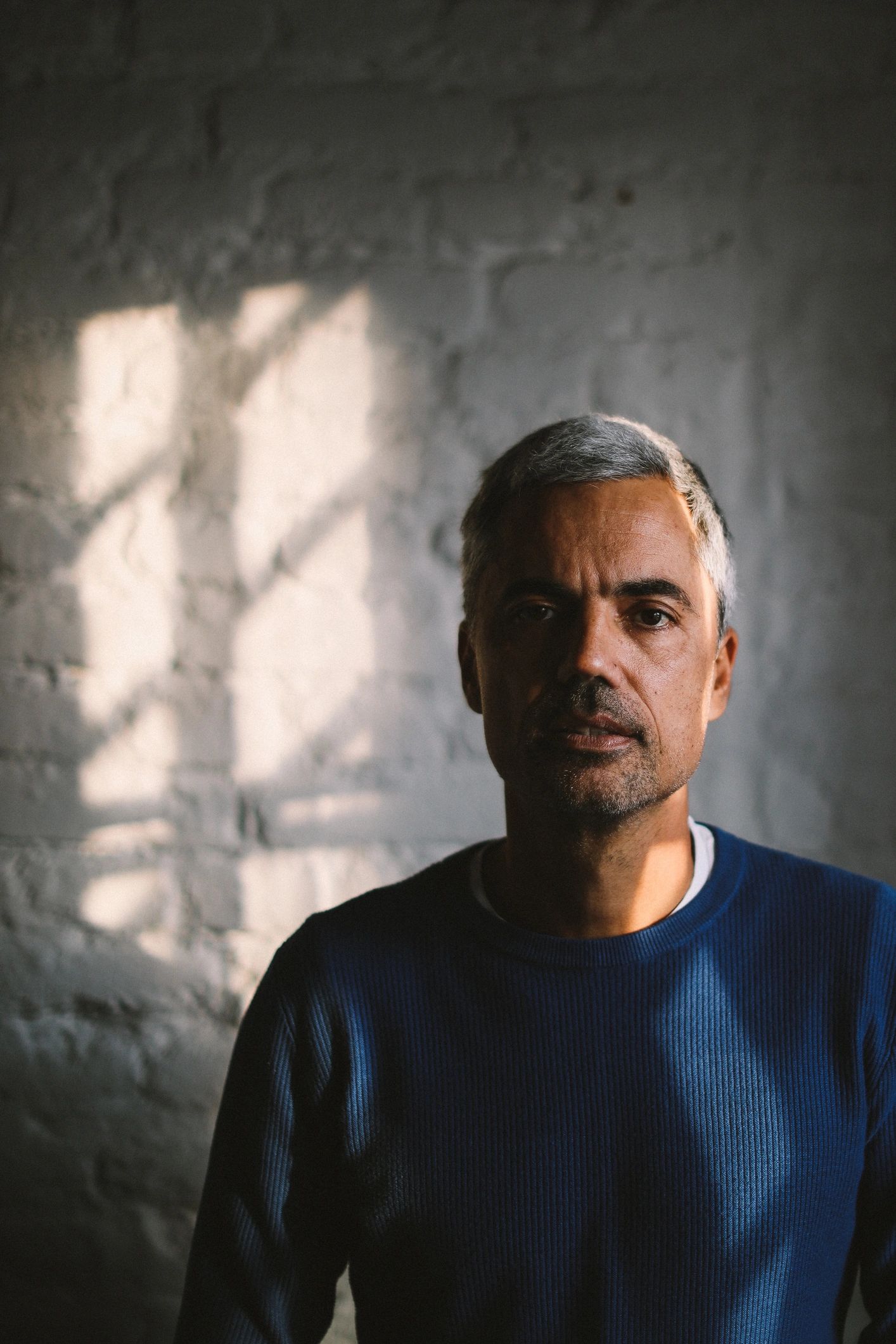 Editorial portrait of a mature man in a dark office setting