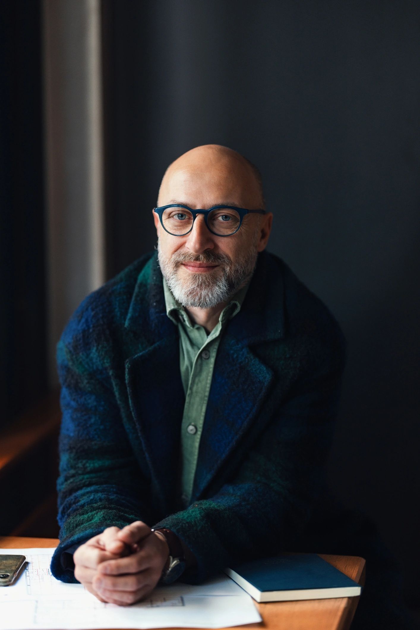 Editorial portrait of a mature man in a dark interior