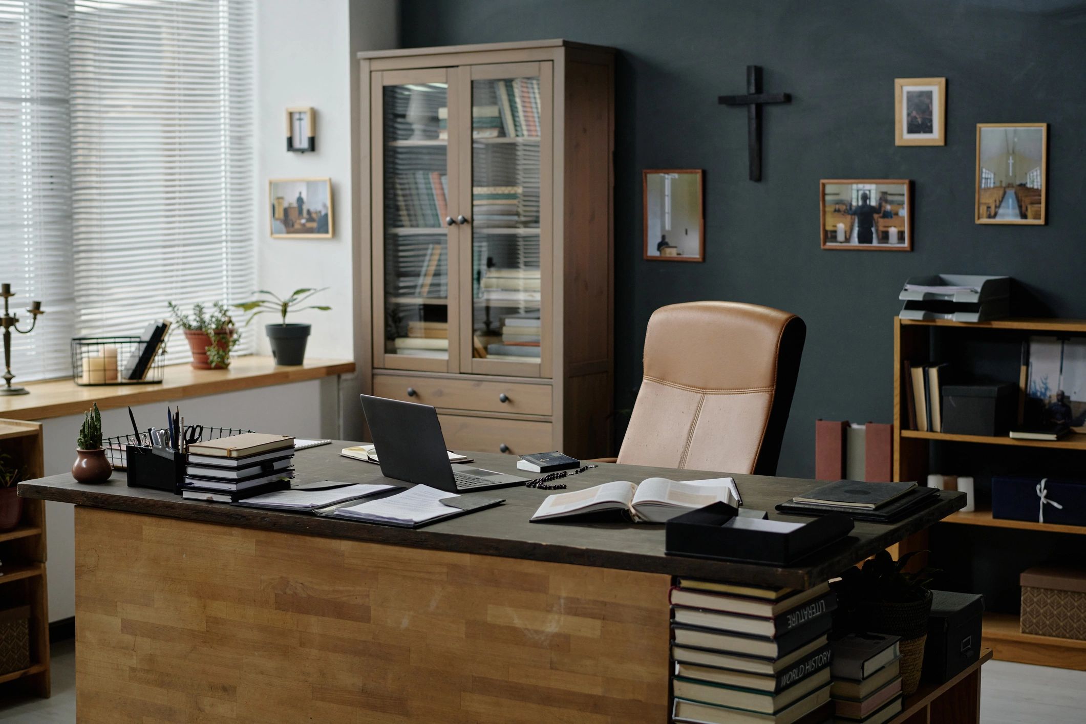 Minimal editorial workspace with bookshelves and desk