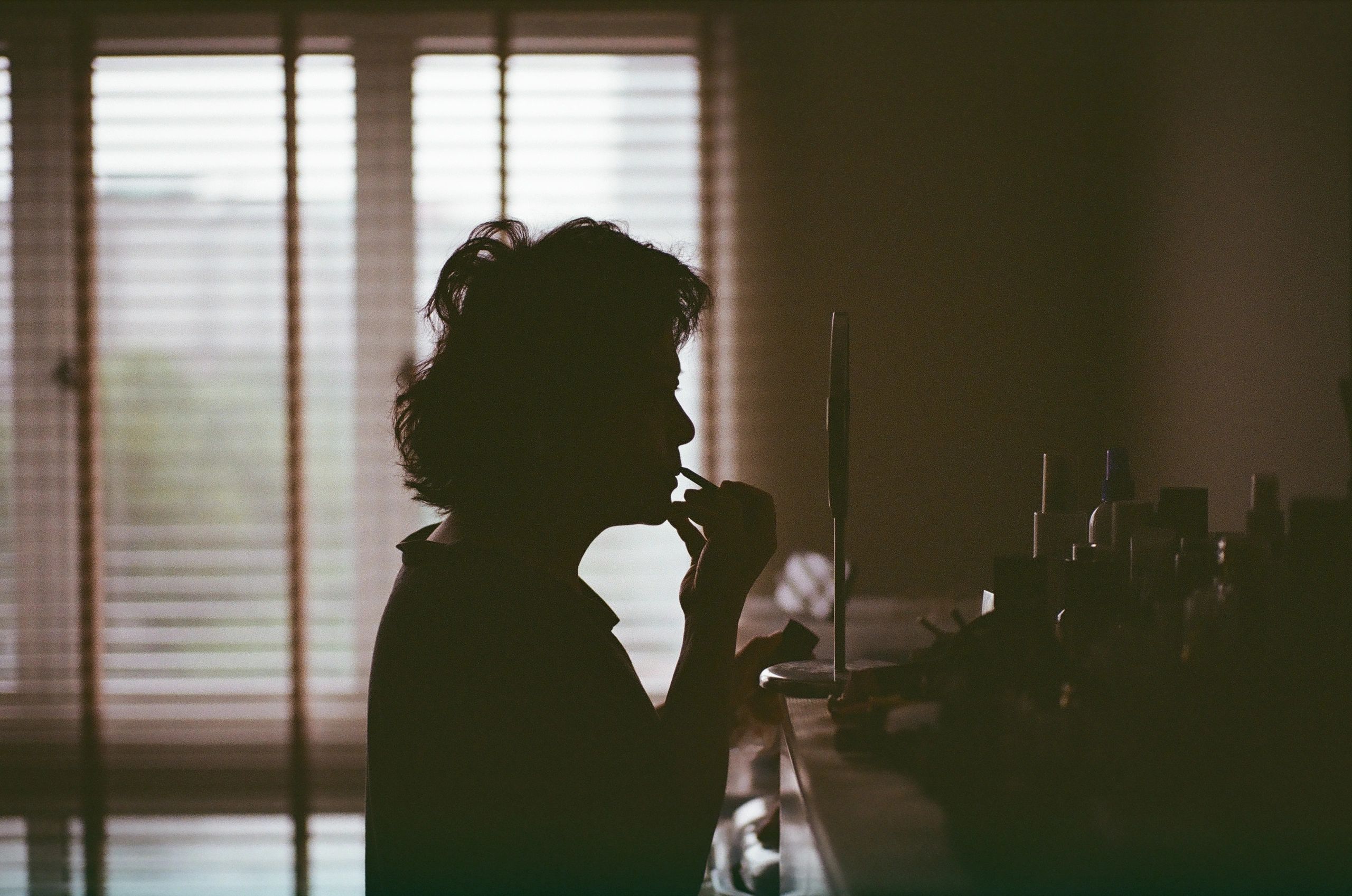 Silhouette at a window representing private reflection and self-definition