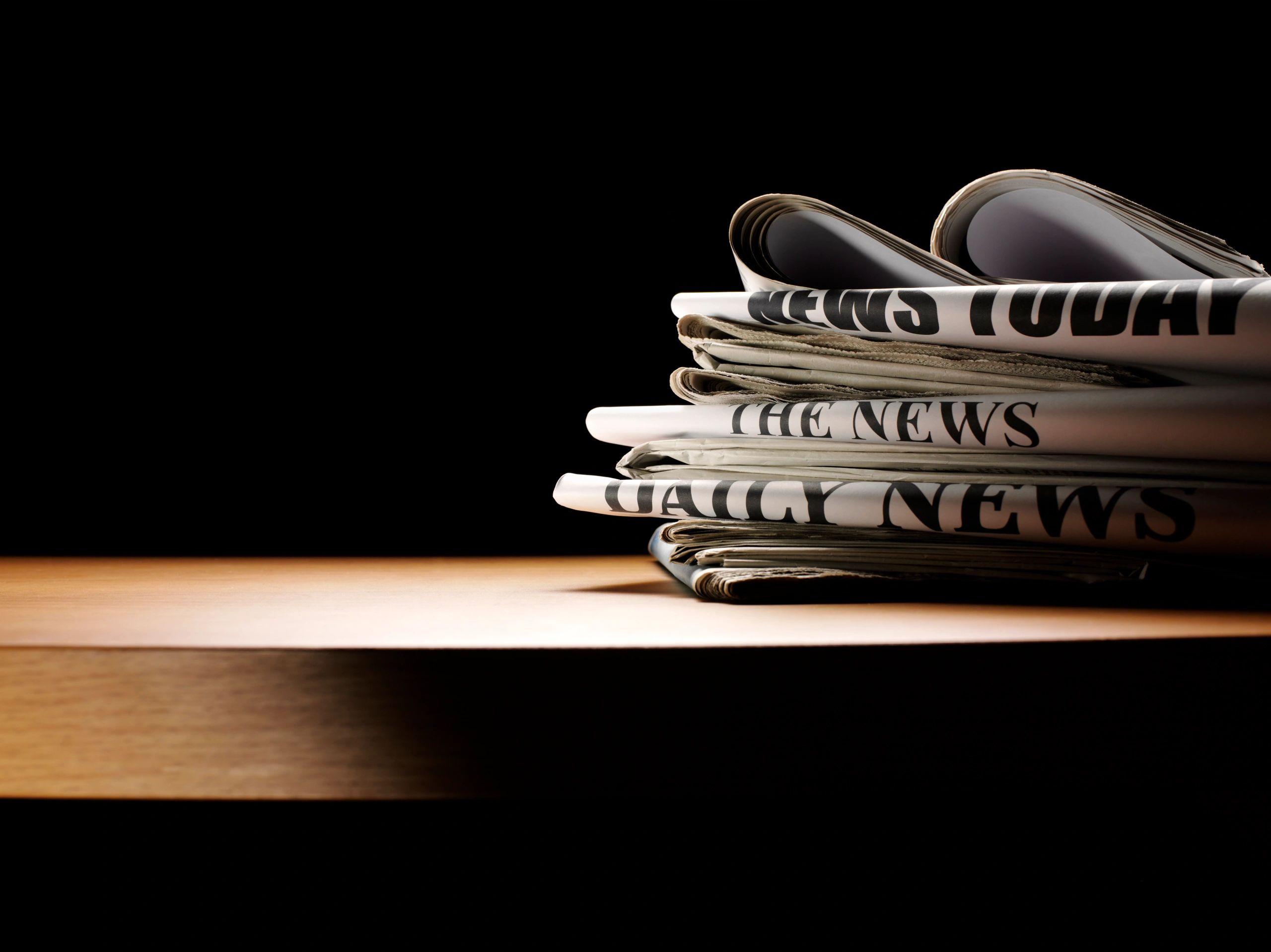 Editorial desk with newspapers and writing space